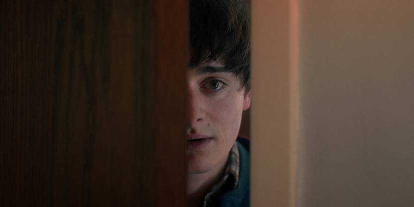 Noah Schnapp as Will Byers looks through the door in 'Stranger Things' Chapter 5.