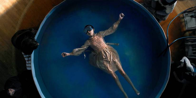 Eleven in a pool of water, blindfolded in the show Stranger Things. 