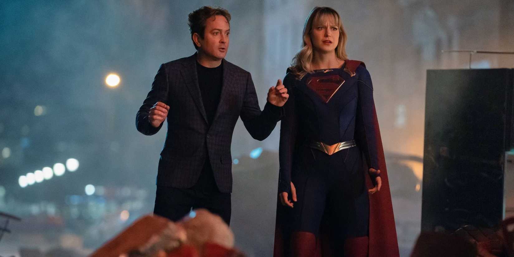 Supergirl and a man stand on a city street looking perplexed in Season 5, Episode 13 It's a Super Life. 