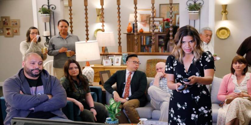 Everyone looks at the TV in Amy's house in Superstore.