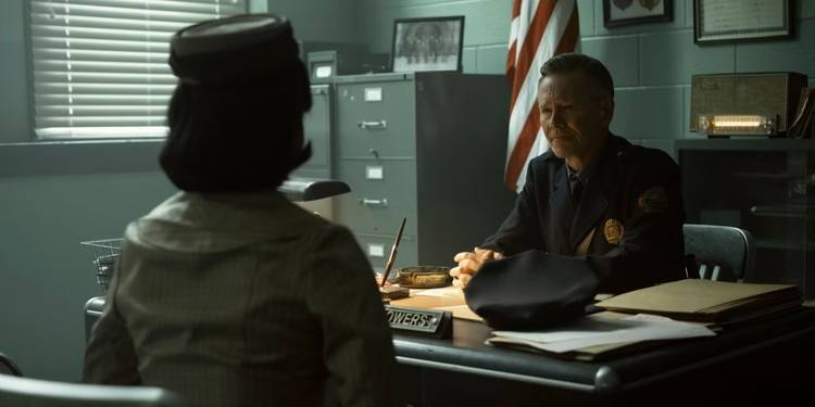 Charlotte (Taylour Paige) sits in Chief Bowers' (Peter Outerbridge) office in 'IT: Welcome to Derry'