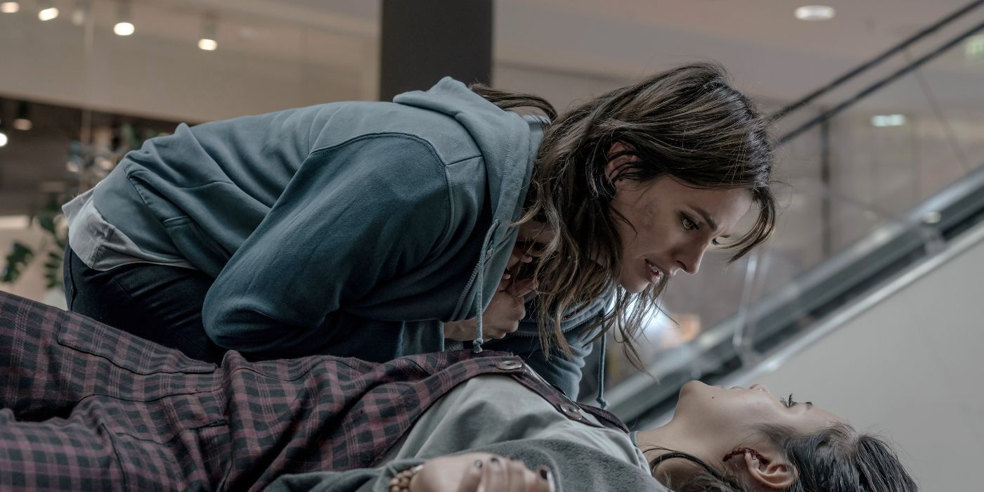 Stana Kantic looks frantic as she leans close to a dying character lying on the ground in Absentia.