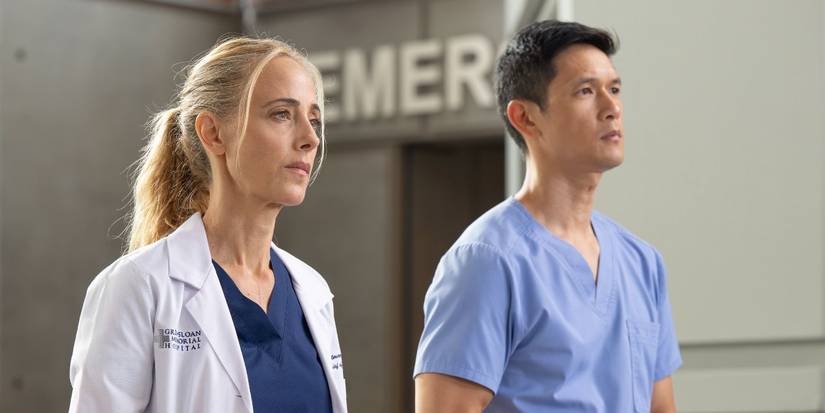 Kim Raver and Harry Shum Jr. walk the hallway in Grey's Anatomy.