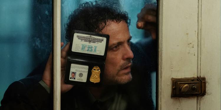 David Lyons holding up an FBI badge in The Beast in Me