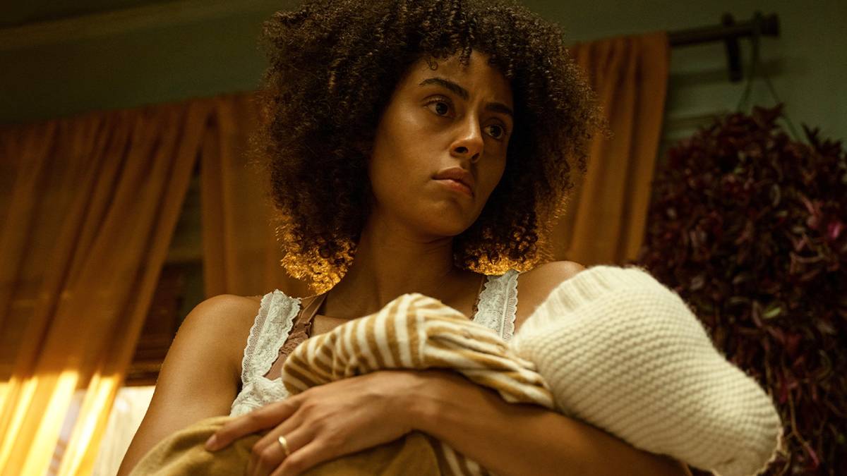 Clark Backo staring into space and holding a baby in The Changeling