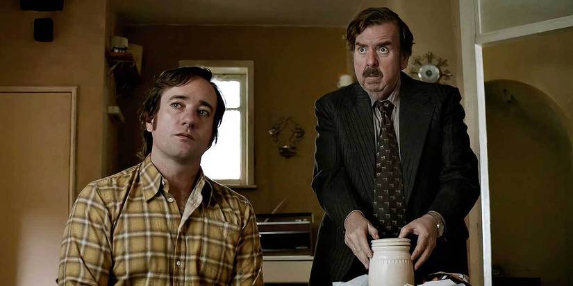 Matthew Macfadyen and Timothy Spall listening to someone off-camera in The Enfield Haunting.