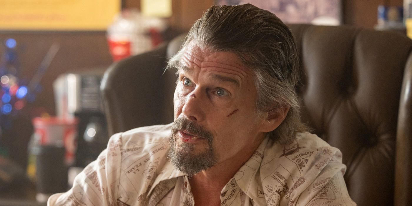 Ethan Hawke as Lee Raybon with a cut on his upper left cheek sitting at a desk in The Lowdown