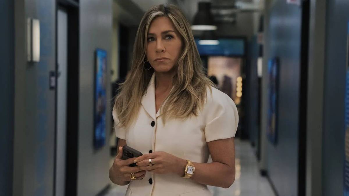 Jennifer Aniston as Alex, standing in a hallway, in 'The Morning Show' Season 4.
