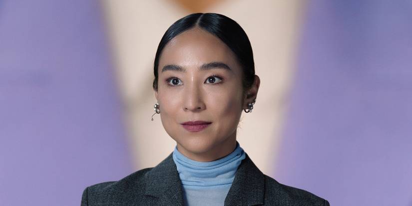 Stella smiling on a colorful background in The Morning Show.