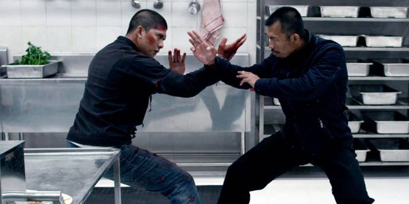 Two men fighting in a kitchen in The Raid 2 - 2014