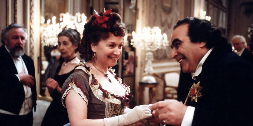 Melmotte smiling and charming one of his female guests in The Way We Live Now