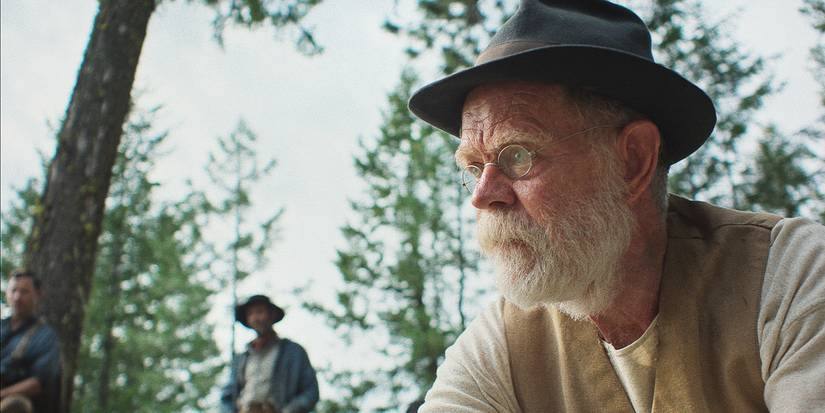 Arn Peeples stares into the distance in a hat and glasses.