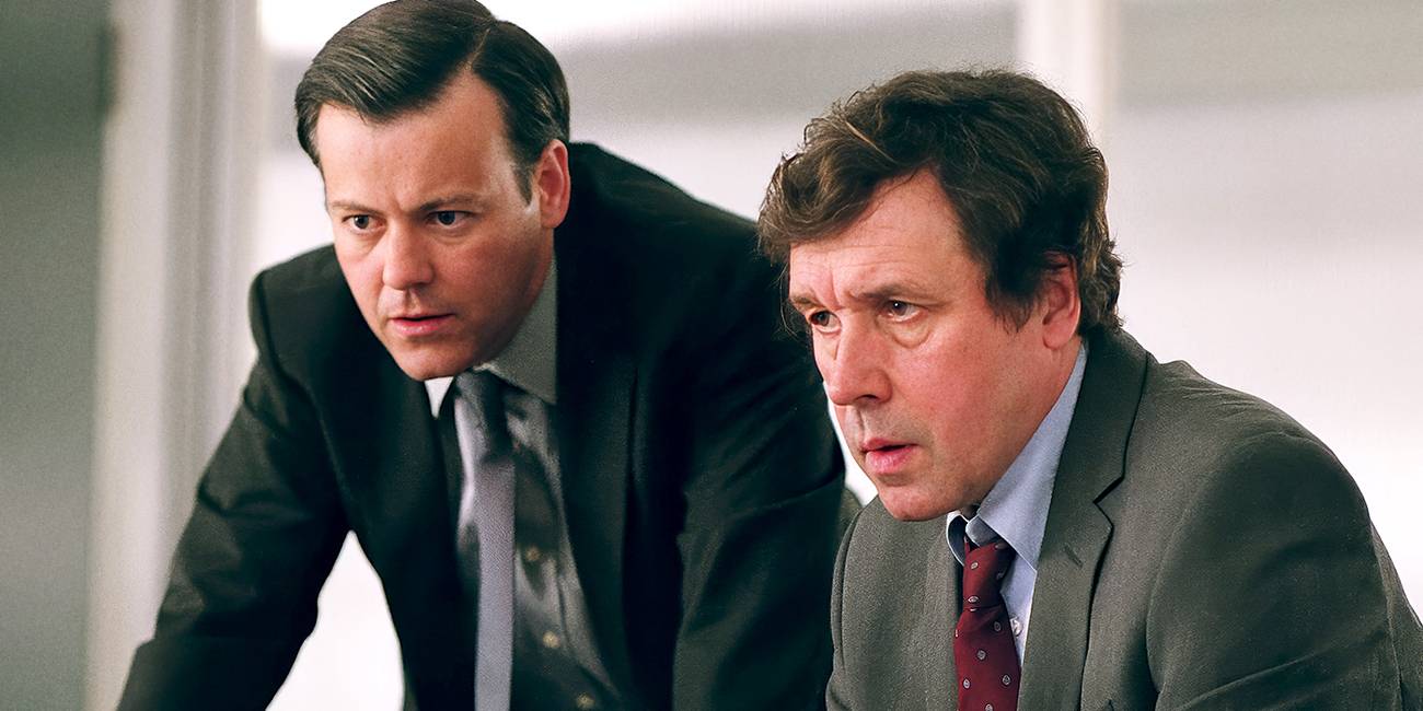 Finch and Dominic looking at something intently in V for Vendetta