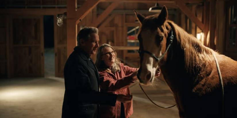 Tim Matheson as Doc Mullins and Annette O'Toole as Hope McCrea with a horse in a stable on 'Virgin River.'