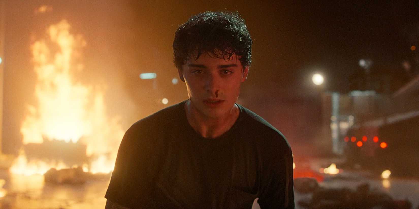 Will Byers looking serious and standing in front of a fire while bleeding from the nose in Stranger Things Season 5 Volume 1