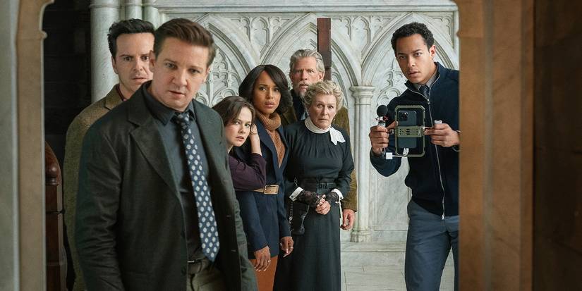 A group of people all looking over toward the camera in shock in Wake Up Dead Man.