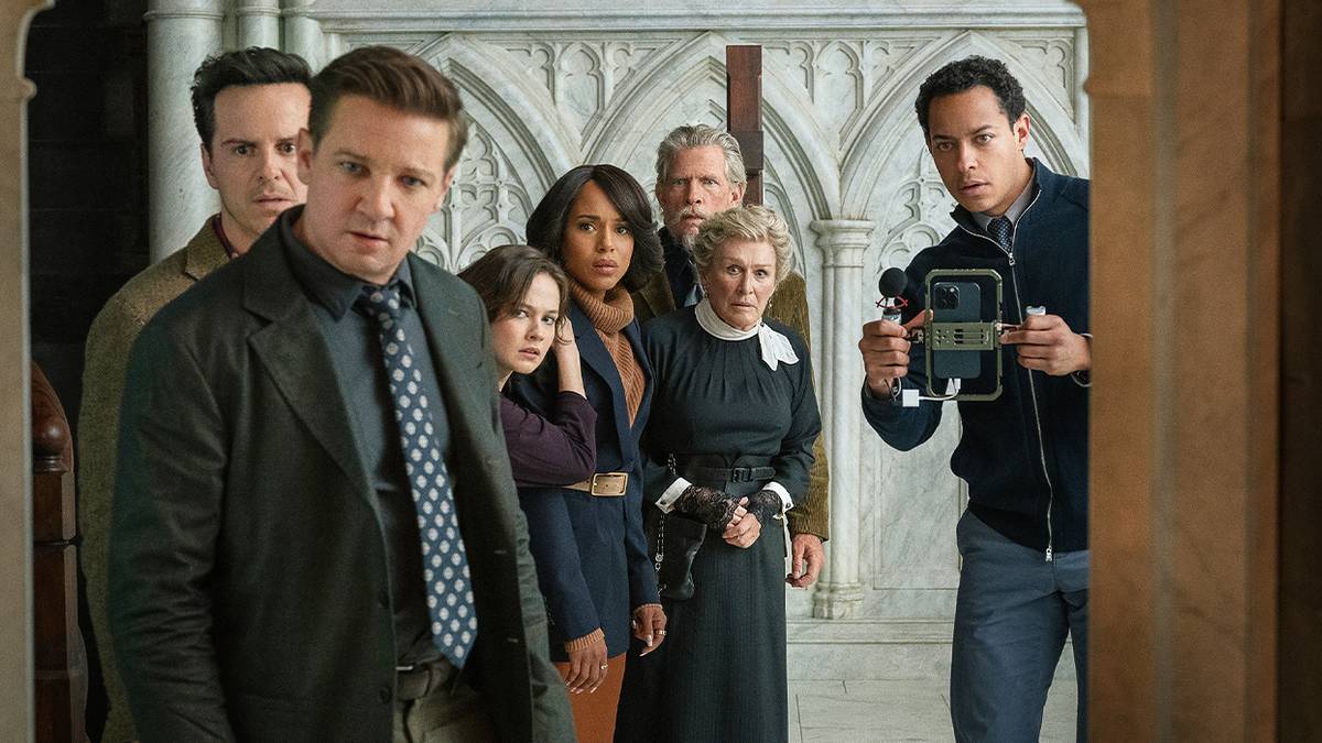 A group of people all looking over toward the camera in shock in Wake Up Dead Man.