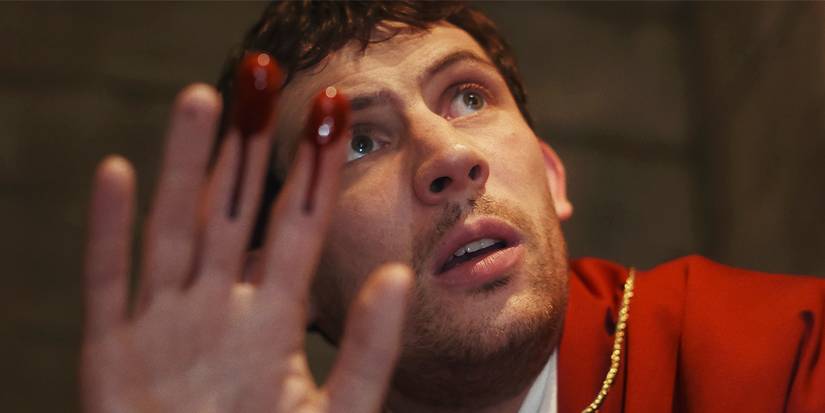 Jud raises his hands with blood on his fingers.