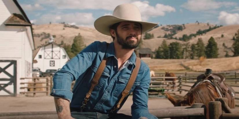 Walker sits on a fence in Yellowstone.