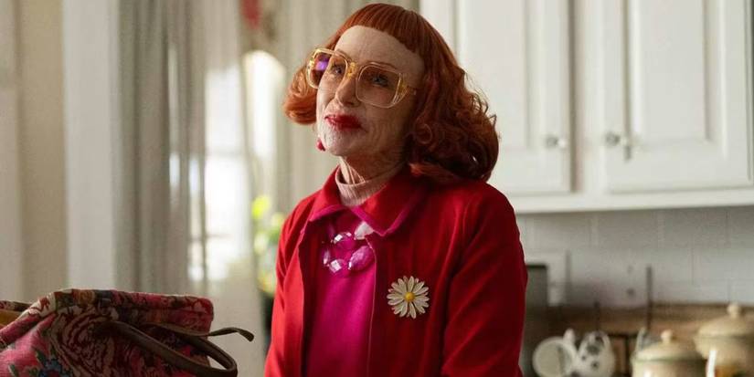 Aunt Gladys sitting down and smiling in Weapons