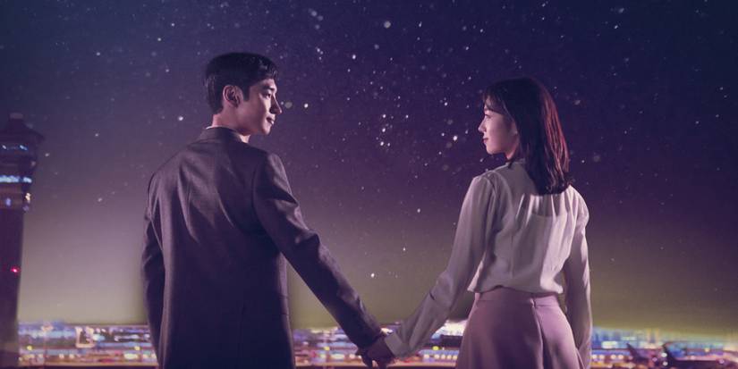 Lee Je-hoon and Chae Soo-bin holding hands and looking at each other gently in Where Stars Land