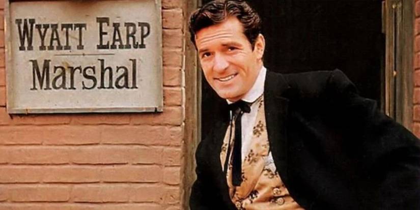 Hugh O'Brian as Wyatt Earp poses by a sign on a building in The Life and Legend of Wyatt Earp.