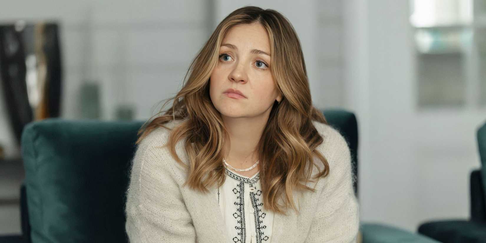 Abby Elliott as Lia sitting in a chair talking to someone who is off-screen in All Her Fault.
