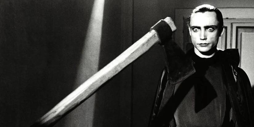 Dracula looking at an axe with wide eyes in Blood for Dracula