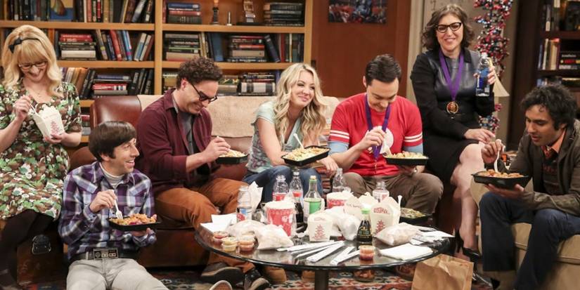 Cast of The Big Bang Theory eat a meal, with Sheldon (Jim Parsons) in his spot.