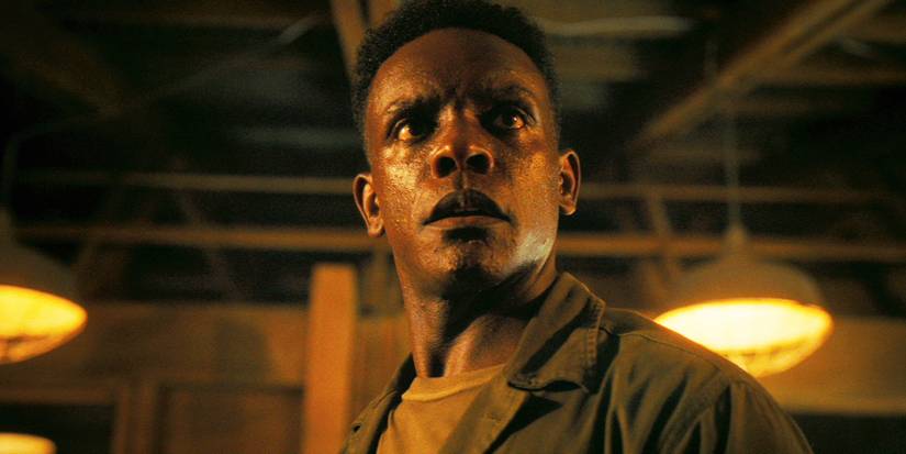 Chris Chalk standing and looking ahead as Dick Hallorrann in IT: Welcome to Derry.