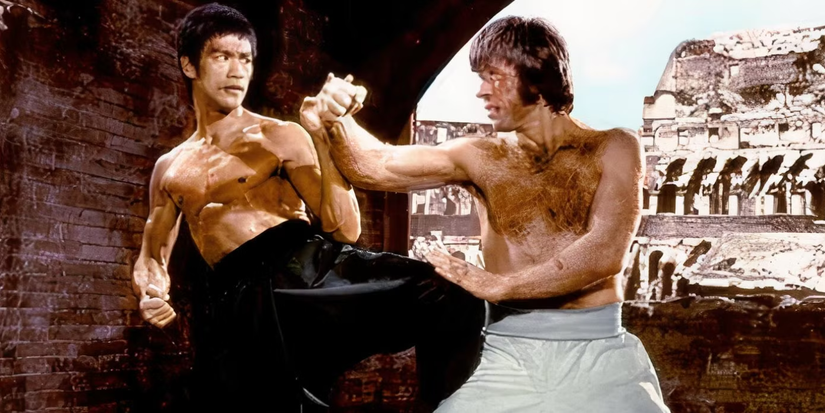 Two shirtless men fight each other in the Colosseum