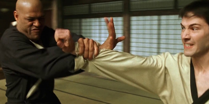 Two men fight each other in an empty Japanese room