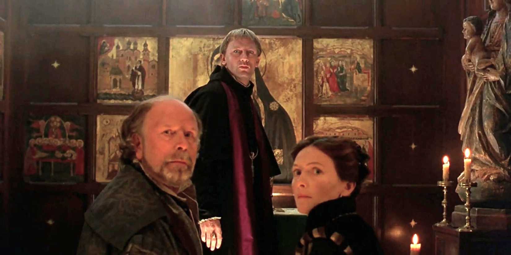 Daniel Craig and two cast members in a church looking tense in a still from Elizabeth, 1998.