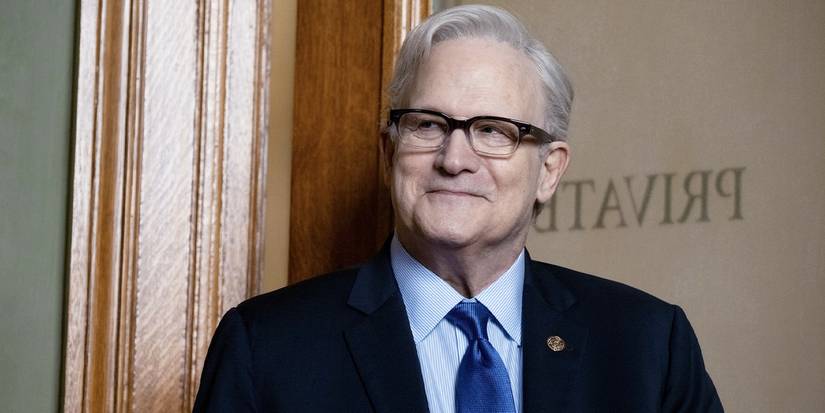 Albert Brooks smiling in glasses and a suit and blue tie in Ella McCay.