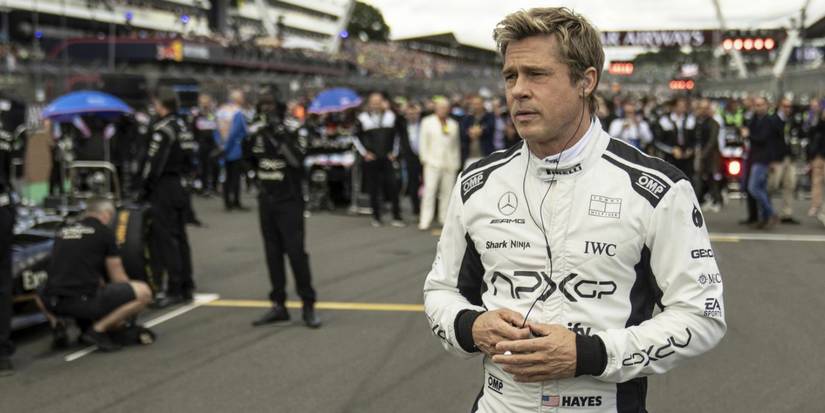 Brad Pitt looking to the distance at the track in F1