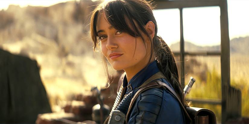 Ella Purnell as Lucy smirking in the Wasteland in Fallout Season 2.