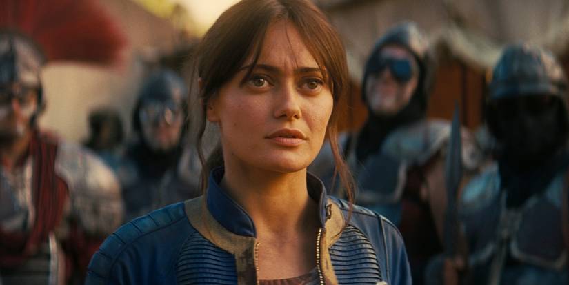 Ella Purnell as Lucy looking perplexed with others behind her in Fallout Season 2 Episode 3