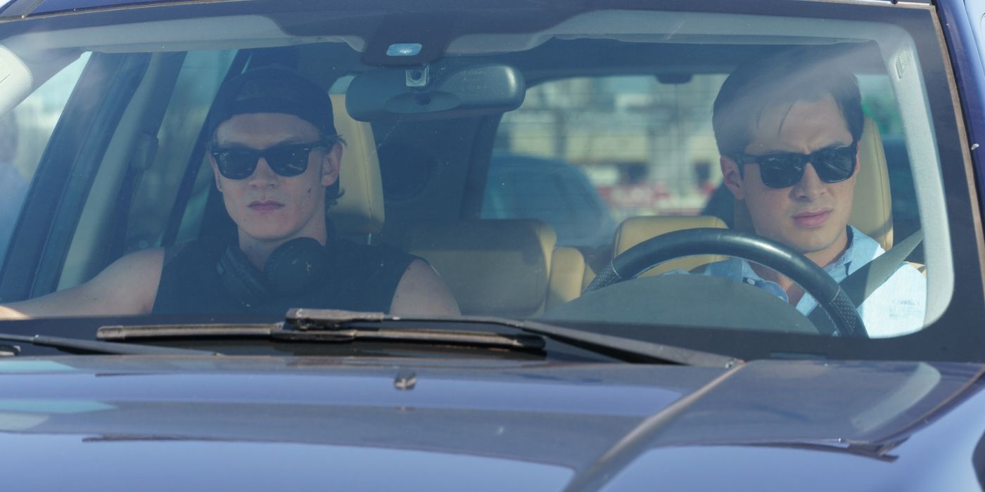 Connor Storrie as Ilya and Hudson Williams as Shane driving in the car to the cottage on 'Heated Rivalry.'