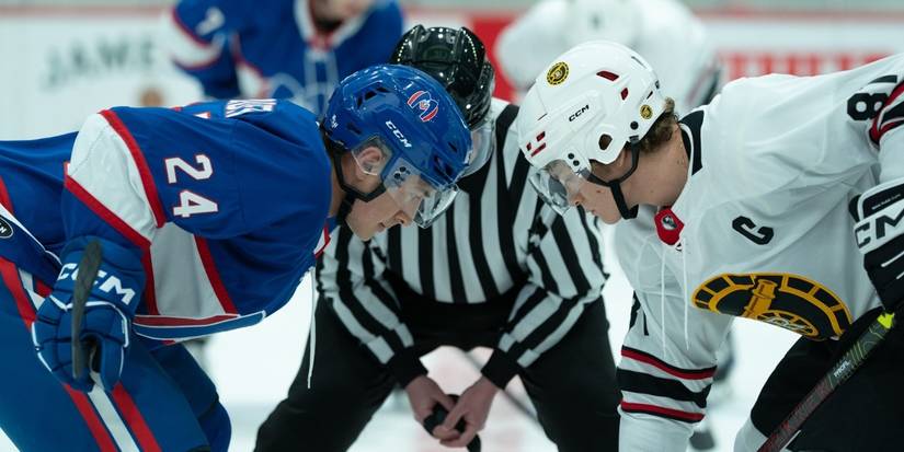 Hudson Williams as Shane Hollander and Connor Storrie as Ilya Rozanov face off on the ice on Heated Rivalry.