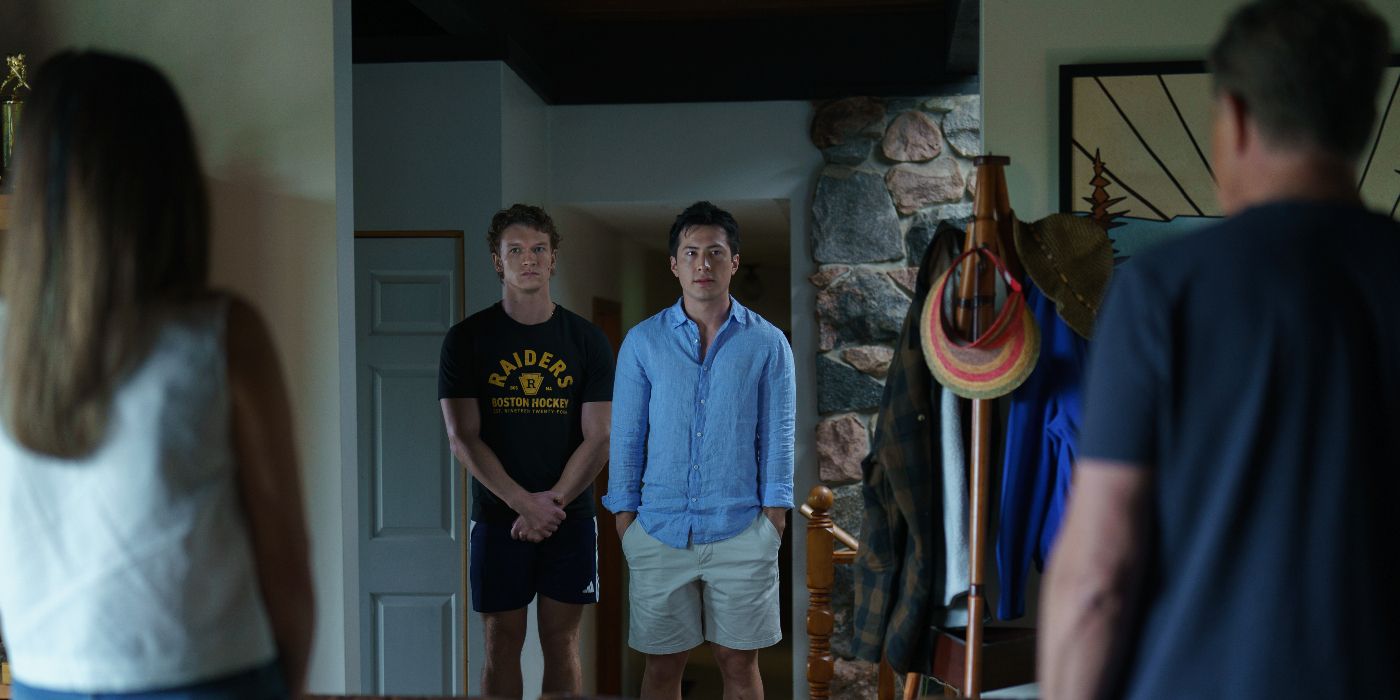 Connor Storrie and Hudson Williams staring ahead at other people in the Heated Rivalry Season 1 finale.
