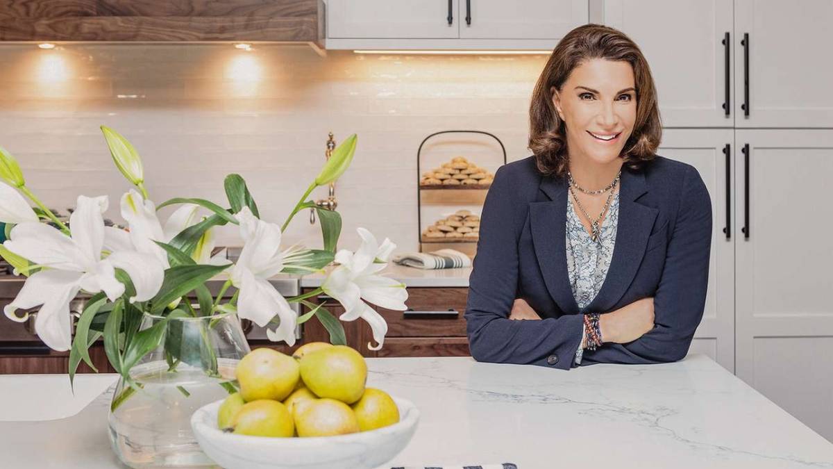 Hilary Farr poses in a kitchen.