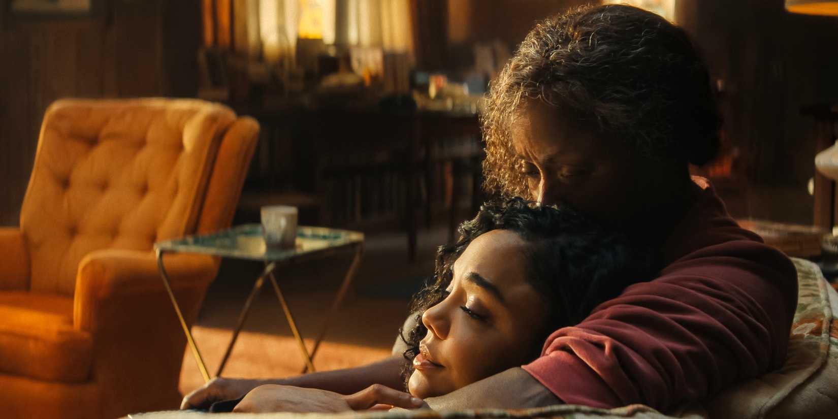 Tessa Thompson as Anna Andrews lying on the couch with Crystal Fox as her mother holding her in His & Hers.