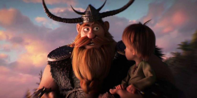 Stoick stands beside a young Hiccup