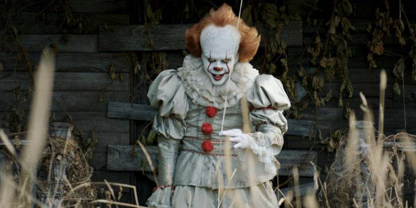 Pennywise holding a red balloon in It