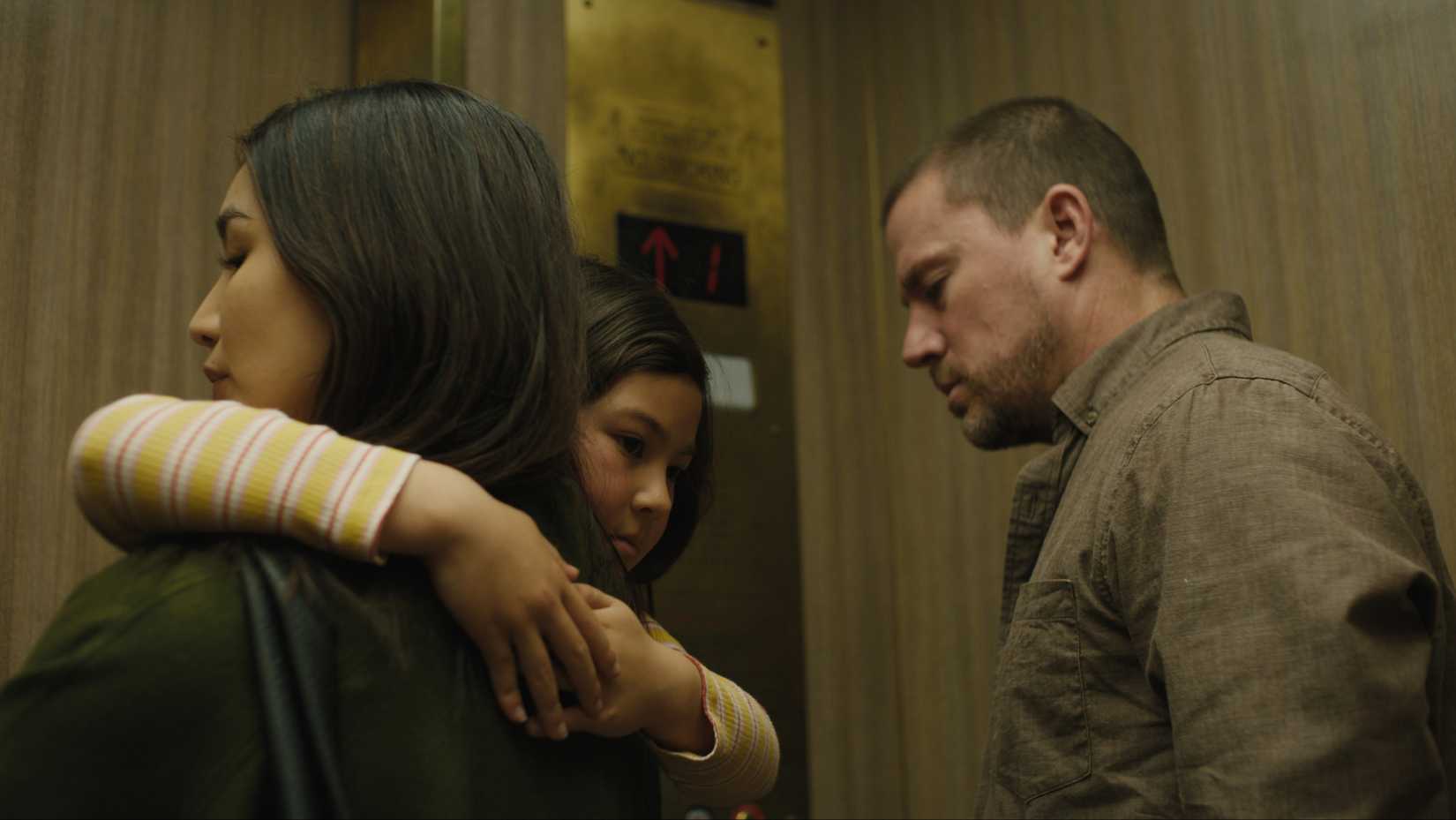 Gemma Chan holding onto a scared Mason Reeves alongside Channing Tatum in Josephine