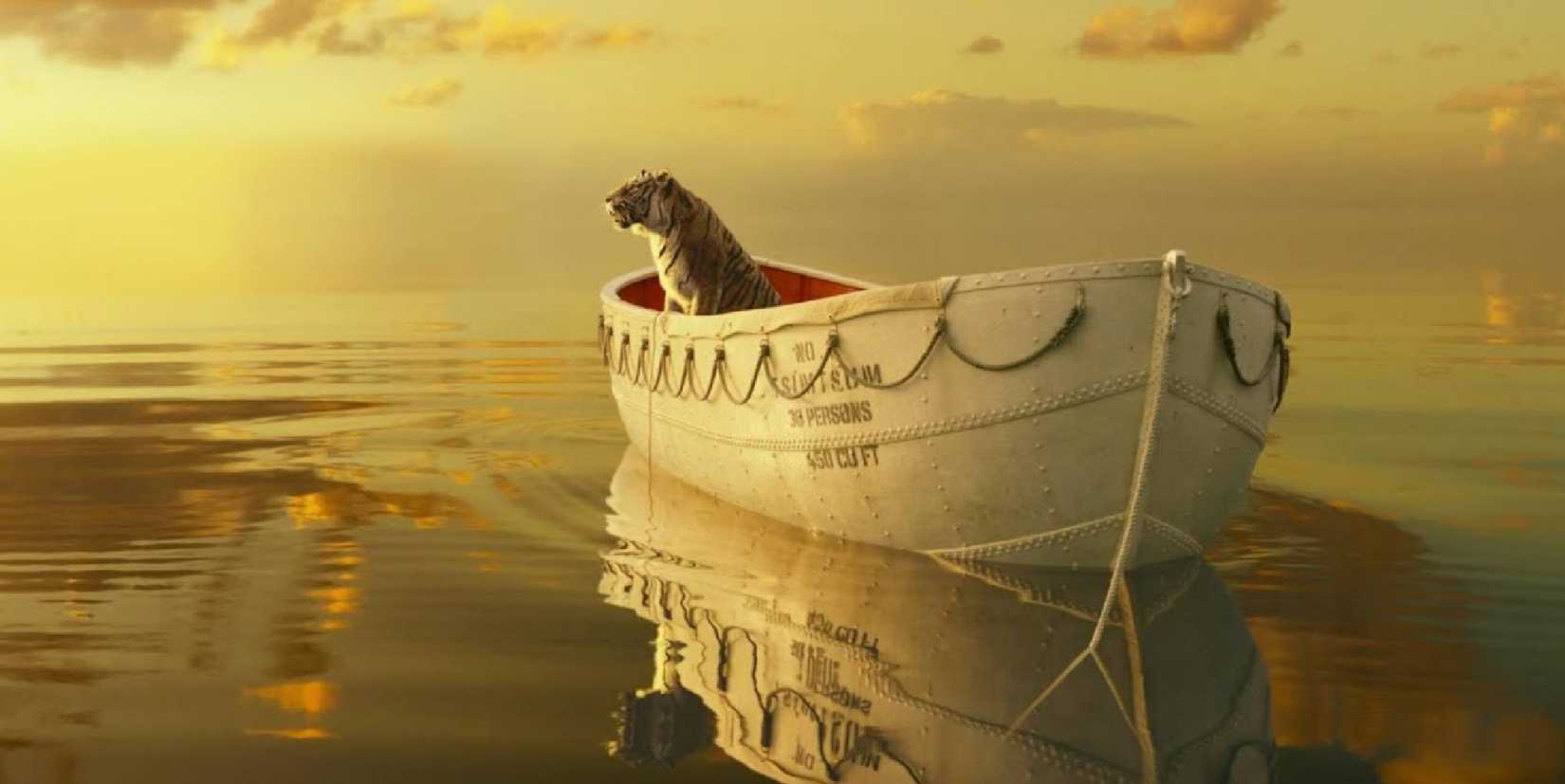 A tiger sits inside a small boat in Life of Pi