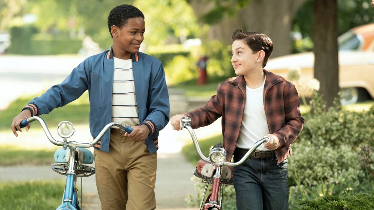 Blake Cameron James as Will Hanlon with Arian S. Cartaya as Rich walking their bikes in IT: Welcome to Derry