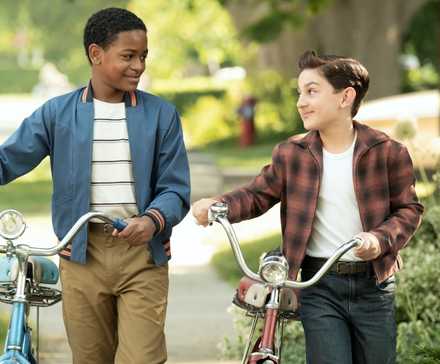 Blake Cameron James as Will Hanlon with Arian S. Cartaya as Rich walking their bikes in IT: Welcome to Derry
