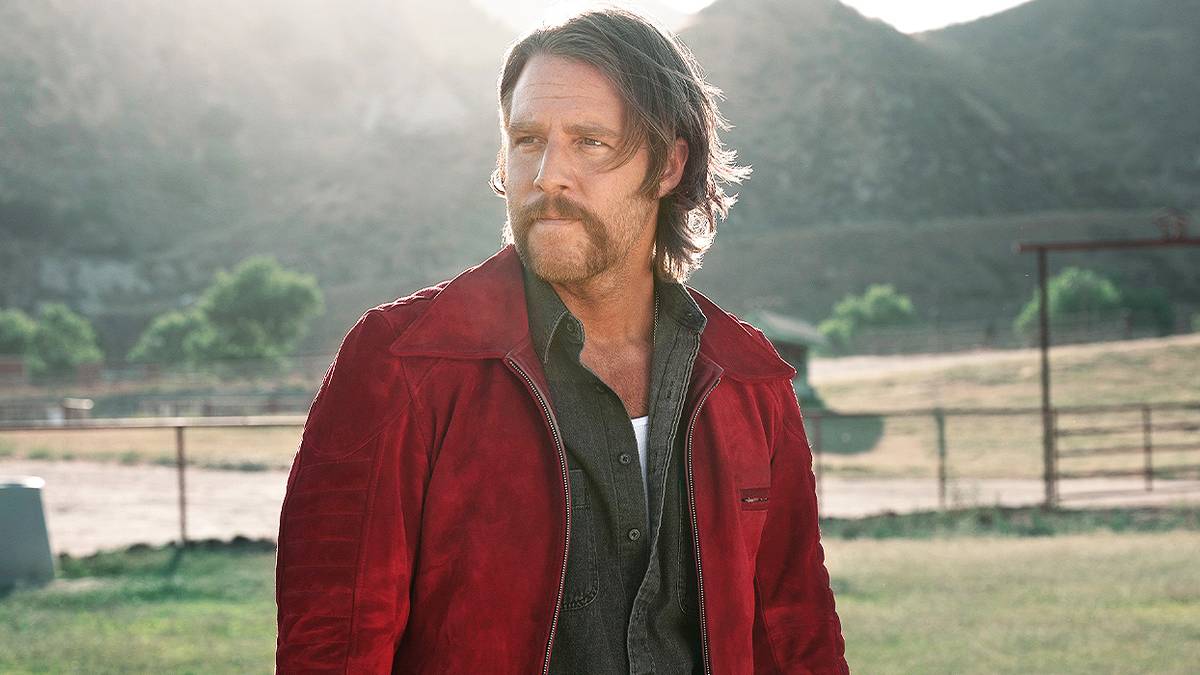 Jake McDorman looking off into the distance in Mrs. Davis