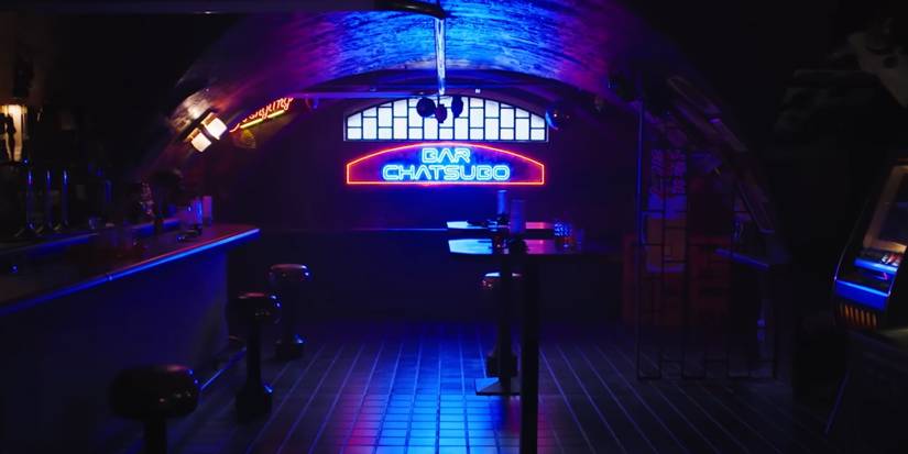 A neon sign reading "Bar Chatsubo" in an empty dark bar